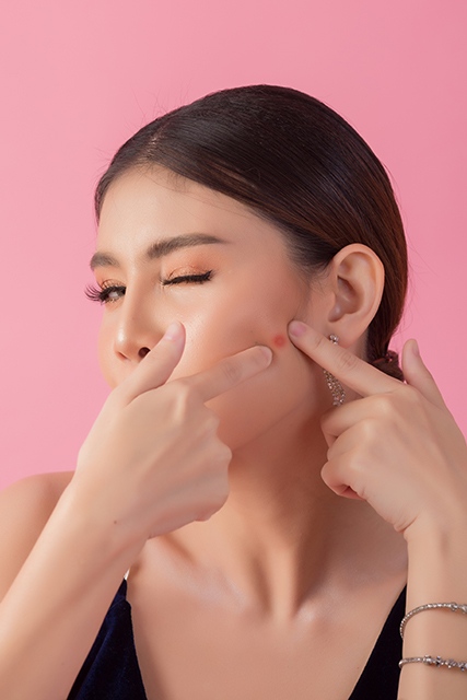 Beautiful woman face. Hand of make-up